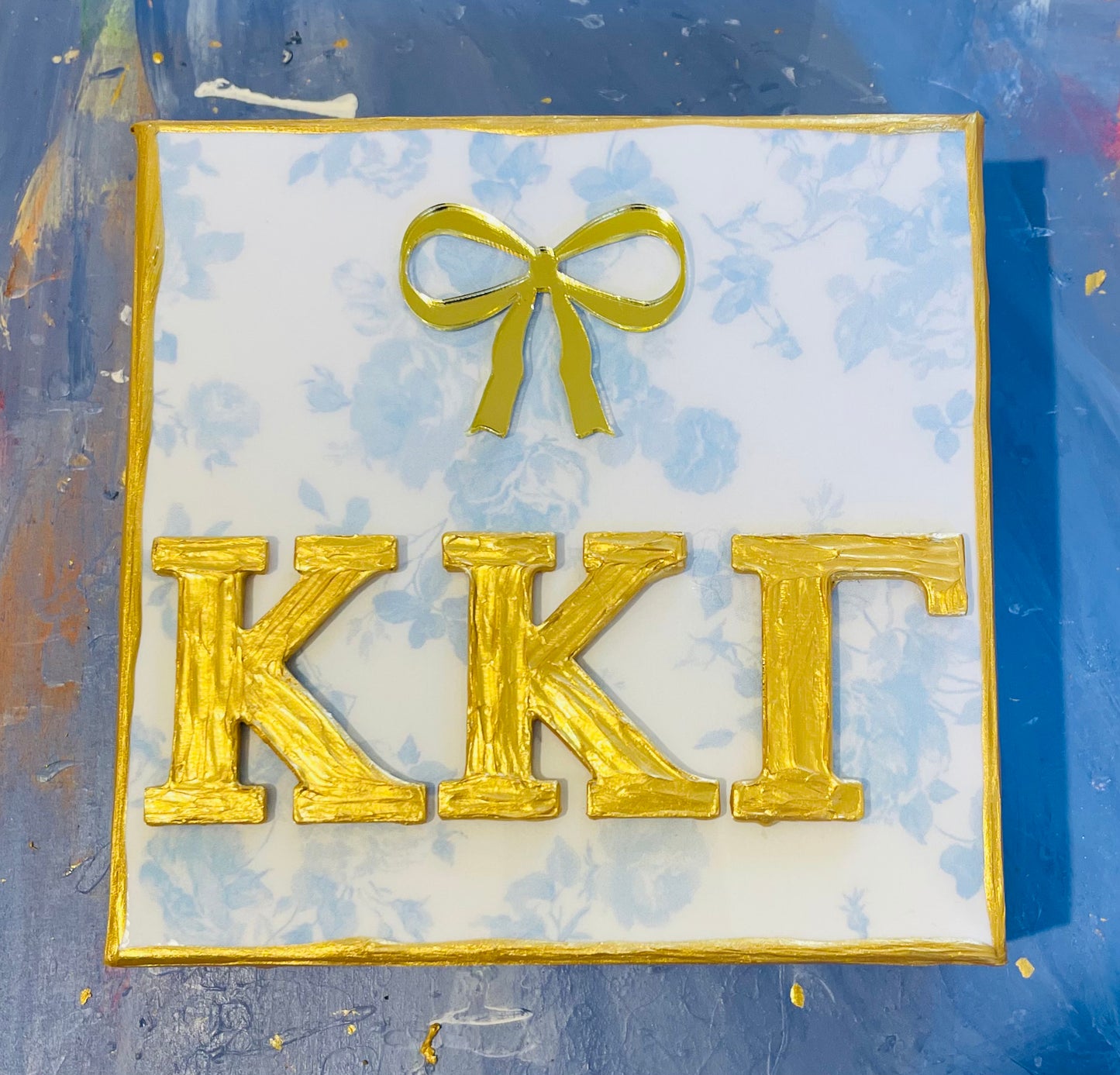 Kappa Kappa Gamma Gold Letters with Bow on a Blue Floral Canvas